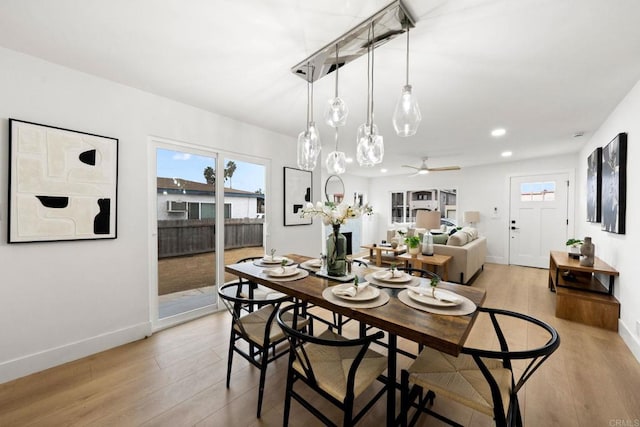 dining space with light hardwood / wood-style flooring and ceiling fan