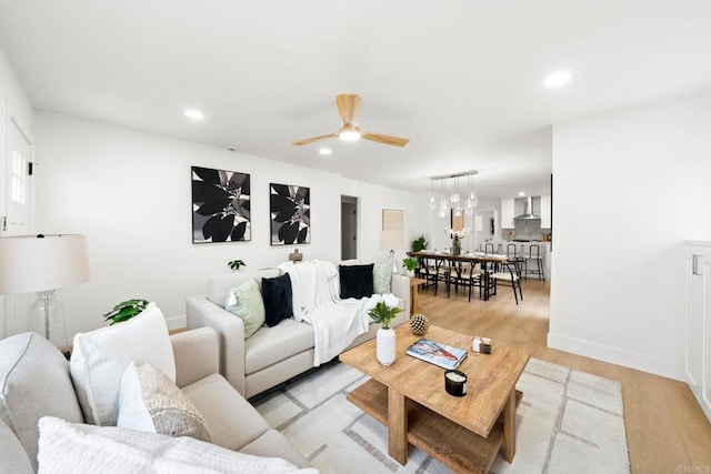 living room featuring ceiling fan and light wood-type flooring