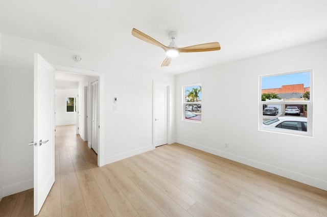 empty room with ceiling fan and light wood-type flooring