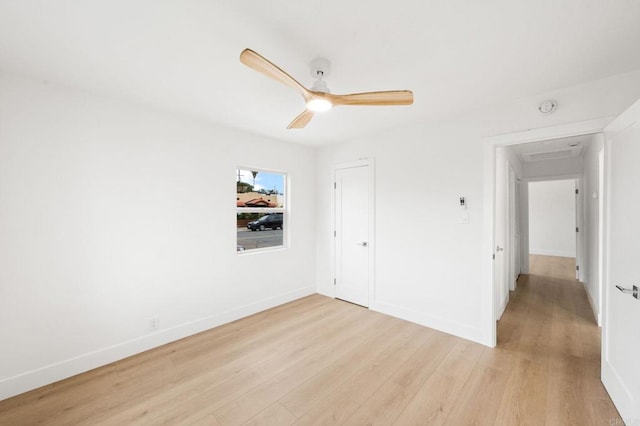 unfurnished bedroom with light hardwood / wood-style flooring, a closet, and ceiling fan