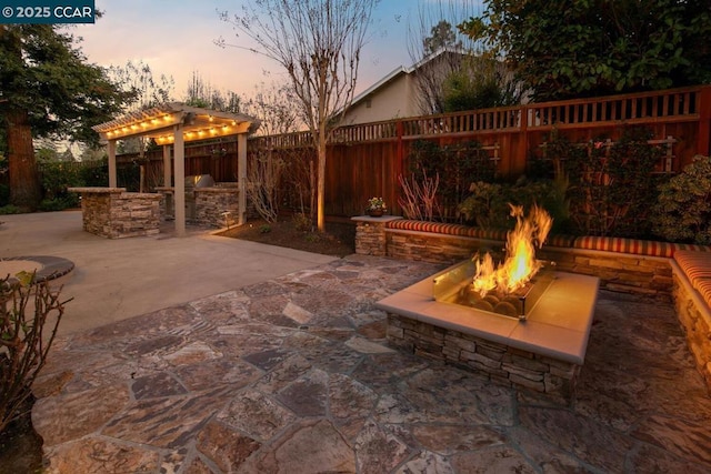 patio terrace at dusk with an outdoor fire pit