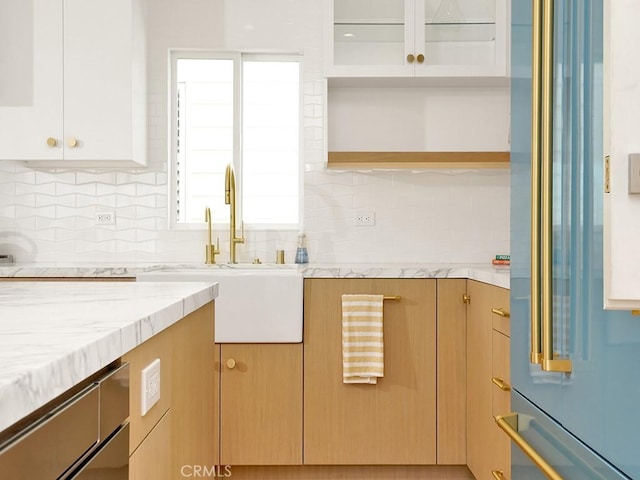 kitchen featuring light brown cabinetry, sink, high quality fridge, decorative backsplash, and white cabinets