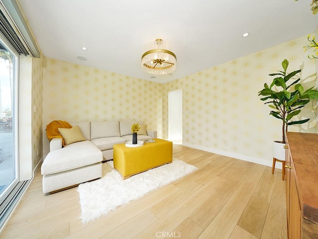 living room with light hardwood / wood-style flooring and a notable chandelier