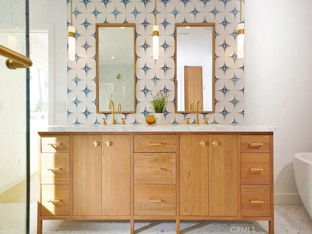 bathroom with vanity and a washtub