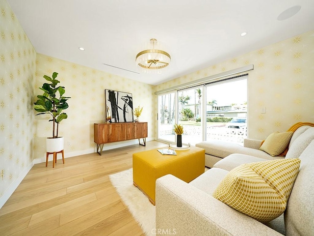 sitting room with wood-type flooring and a chandelier