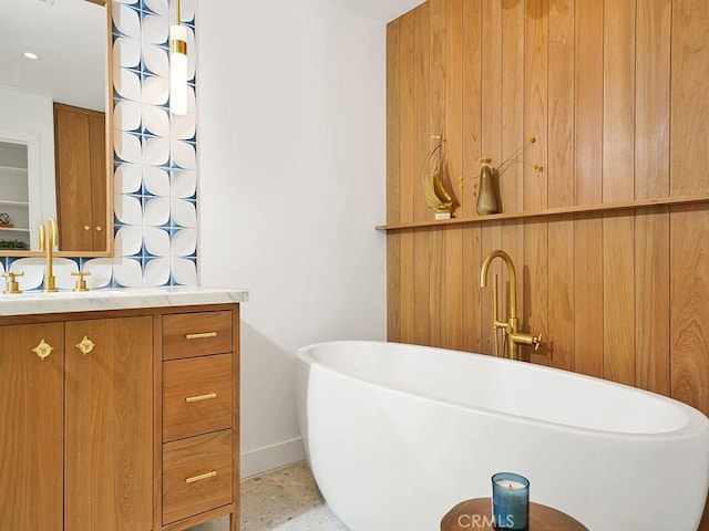 bathroom featuring vanity and a tub