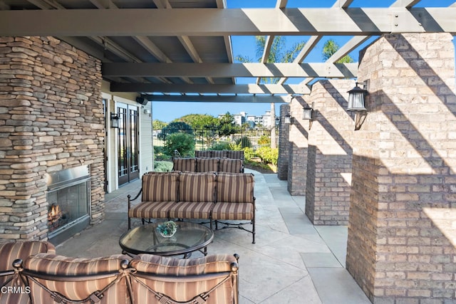 view of patio / terrace featuring an outdoor stone fireplace