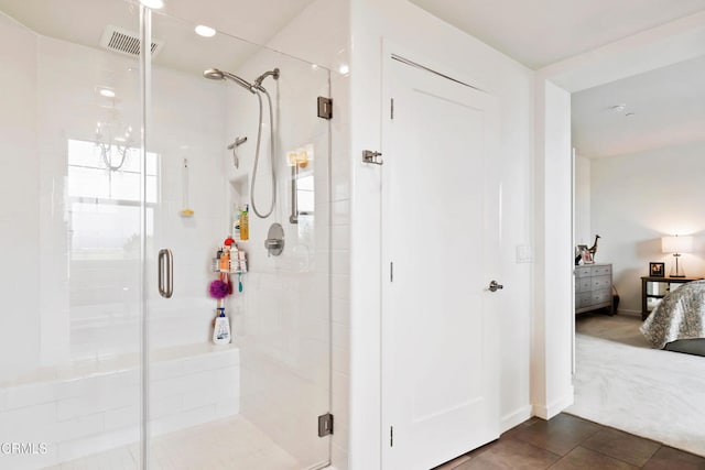 bathroom featuring tile patterned floors and a shower with door