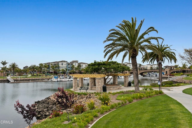 surrounding community featuring a water view and a yard