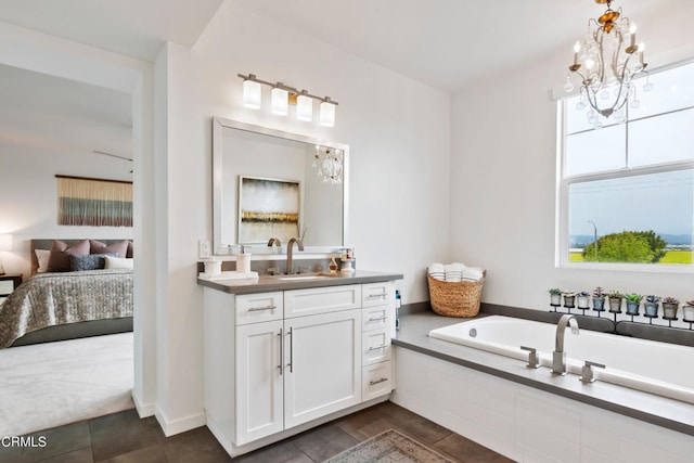 bathroom featuring vanity, a relaxing tiled tub, a notable chandelier, and tile patterned floors