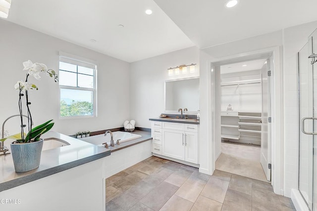 bathroom with a shower with door and vanity