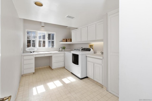 washroom featuring separate washer and dryer and cabinets