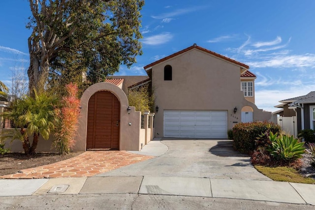 mediterranean / spanish-style house with a garage