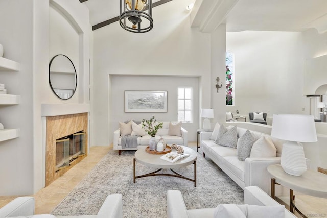 living room with a tile fireplace and light tile patterned flooring