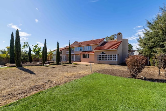 back of house featuring a yard