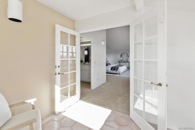 interior space with french doors and light colored carpet