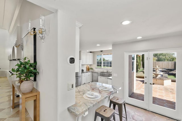 dining room featuring sink and french doors