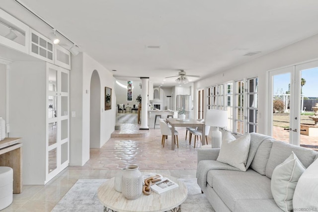 living room with rail lighting, ceiling fan, and french doors