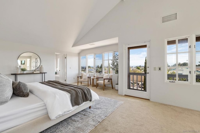 bedroom featuring light carpet, access to exterior, and high vaulted ceiling