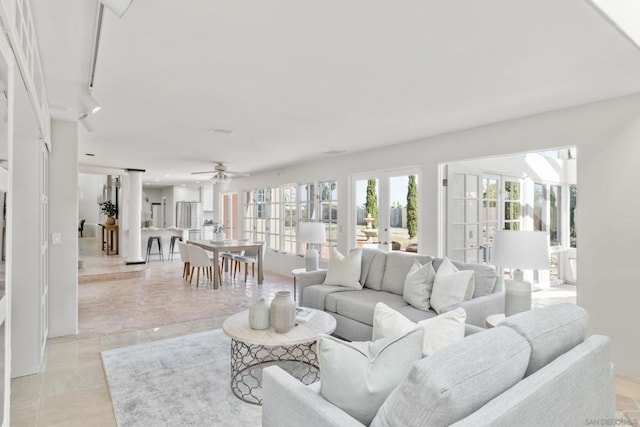 living room featuring french doors, track lighting, and ceiling fan