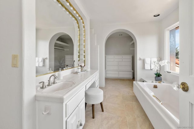 bathroom featuring vanity, a bathtub, and tile patterned floors