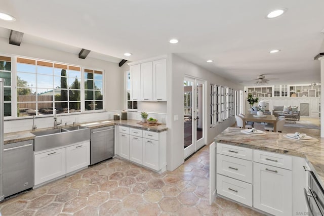 kitchen featuring white cabinetry, sink, and stainless steel dishwasher