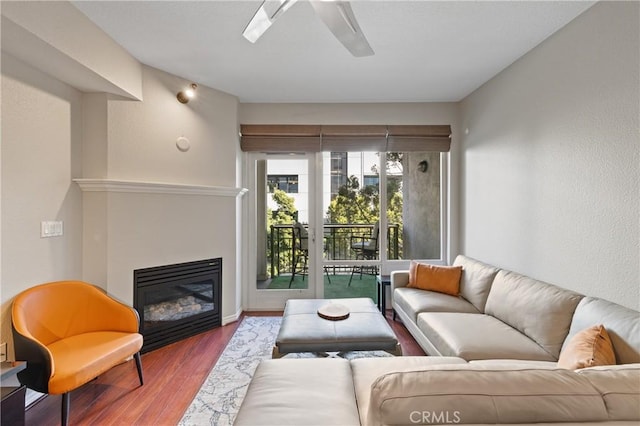 living room with hardwood / wood-style floors and ceiling fan