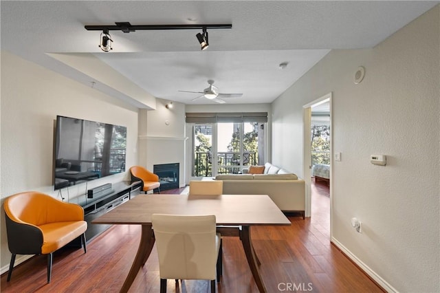 dining room featuring hardwood / wood-style flooring, ceiling fan, and track lighting