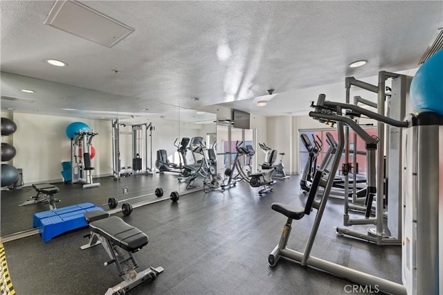 gym with a textured ceiling