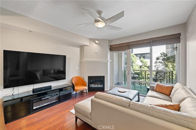 living room with hardwood / wood-style flooring and ceiling fan