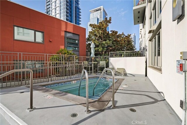 view of pool with a patio and a community hot tub