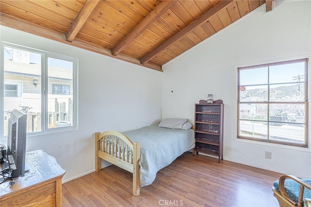 bedroom featuring hardwood / wood-style flooring, vaulted ceiling with beams, and wooden ceiling