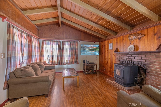 living room featuring vaulted ceiling with beams, wood ceiling, hardwood / wood-style floors, and a wood stove