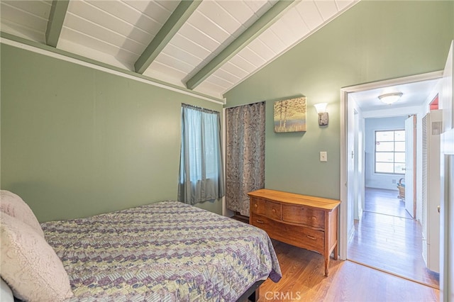 bedroom with vaulted ceiling with beams, wood ceiling, and wood-type flooring