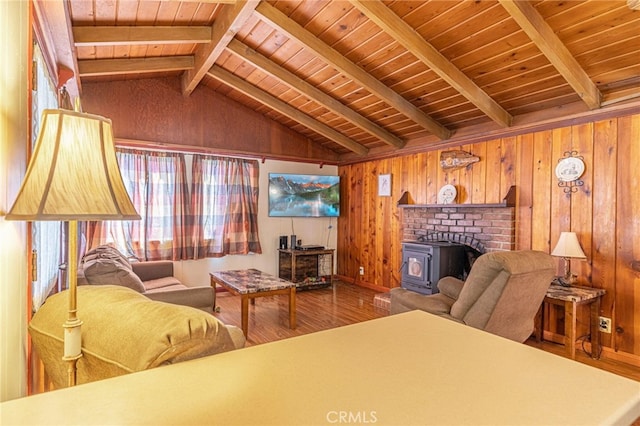 living room with vaulted ceiling with beams, hardwood / wood-style flooring, wooden walls, and wooden ceiling