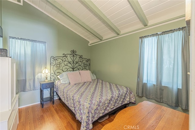 bedroom featuring multiple windows, vaulted ceiling with beams, wood ceiling, and hardwood / wood-style floors