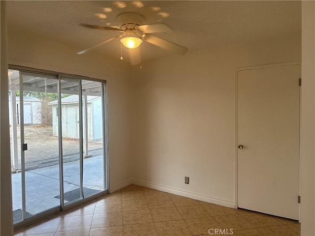 empty room featuring light tile patterned floors, a textured ceiling, and ceiling fan