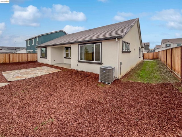 back of house with a patio and central air condition unit