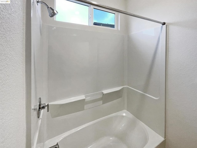 bathroom with bathing tub / shower combination