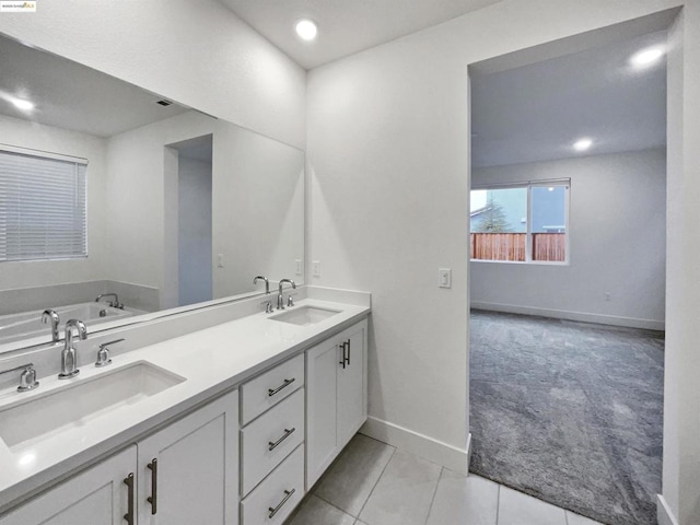 bathroom with vanity, a washtub, and tile patterned floors