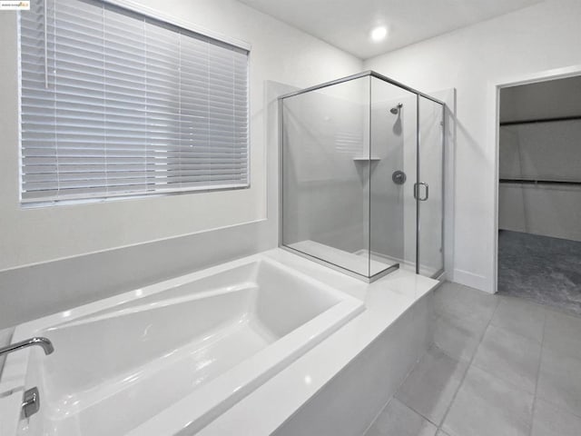 bathroom featuring tile patterned flooring and plus walk in shower