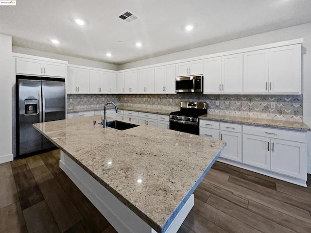 kitchen with appliances with stainless steel finishes, sink, and white cabinets