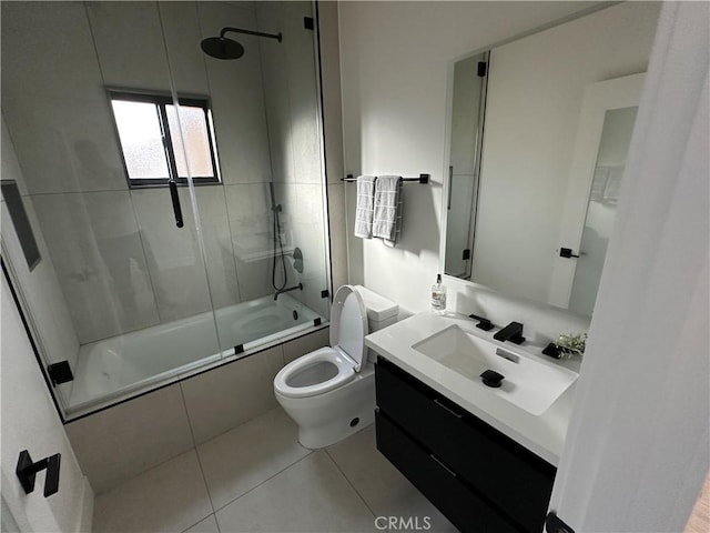 full bathroom featuring tile patterned flooring, bath / shower combo with glass door, vanity, and toilet