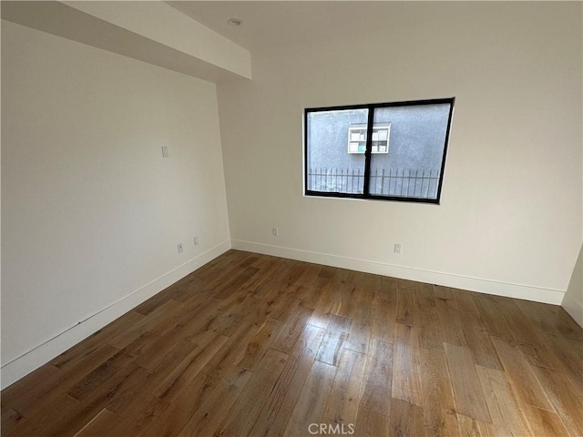 spare room featuring wood-type flooring