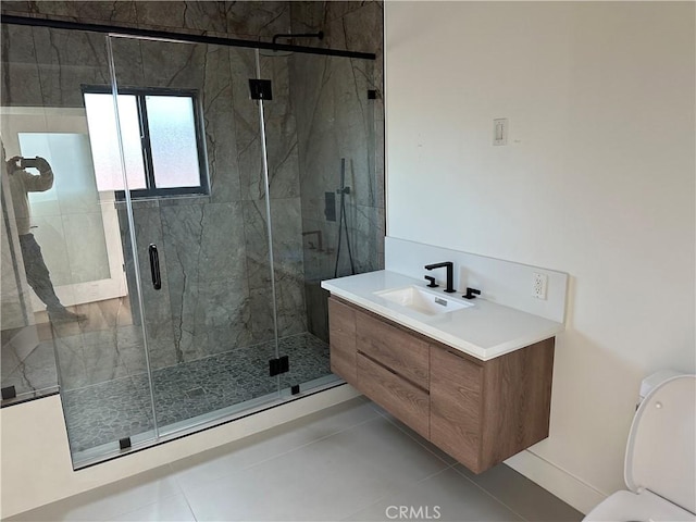 bathroom with vanity, a shower with shower door, and tile patterned floors