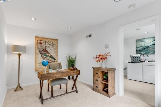 office featuring washing machine and clothes dryer and light carpet