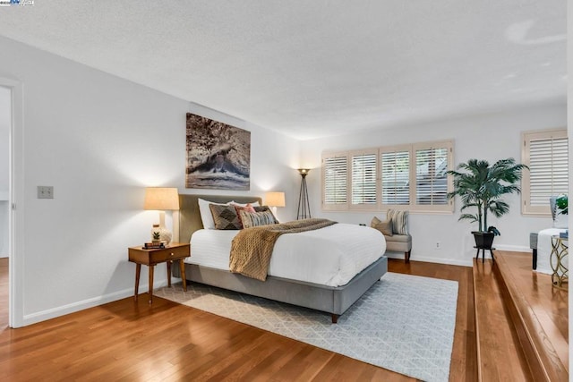 bedroom with hardwood / wood-style floors