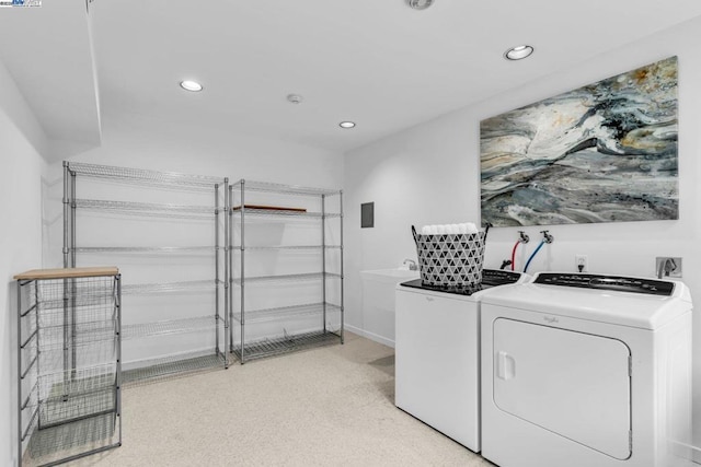 clothes washing area featuring separate washer and dryer