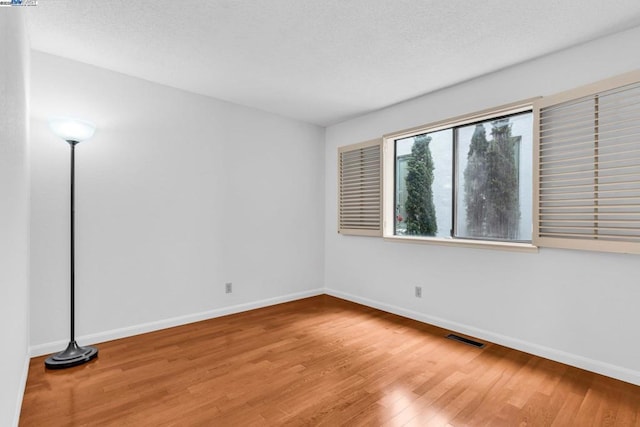 empty room with hardwood / wood-style floors