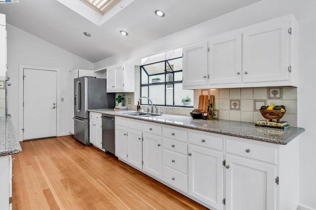 kitchen featuring sink and white cabinets